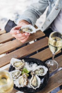 a-plate-of-oysters-two-glasses-of-white-wine-on-a-2021-09-03-04-10-44-utc